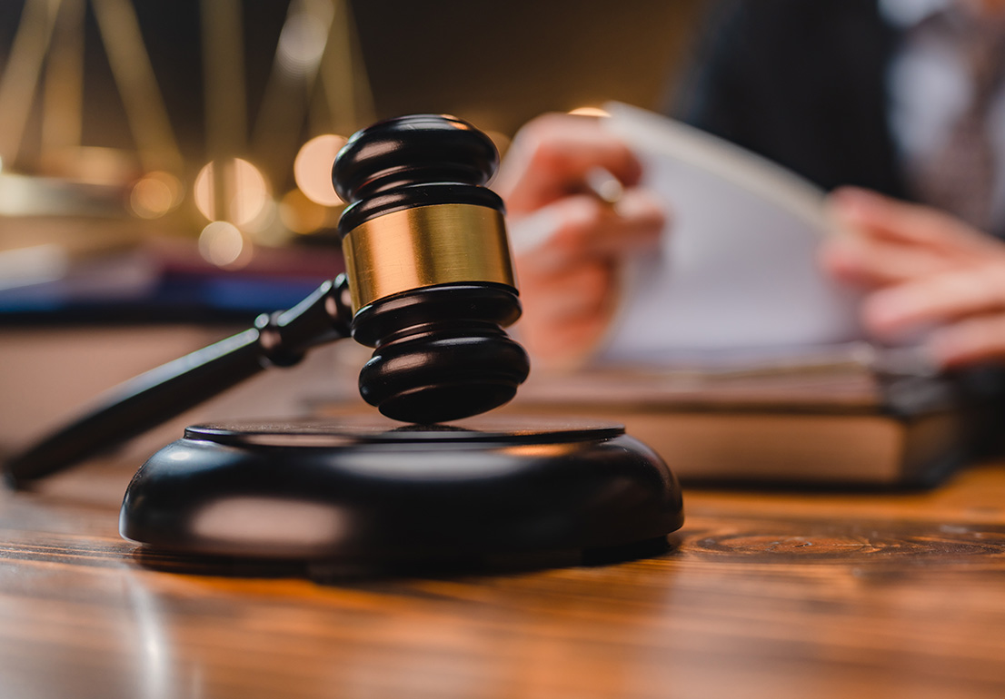 A judge’s gavel resting on a sound block